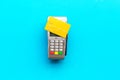 Paypass technology. Bank card lays on payment terminal on blue background top view space for text