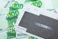 Payroll slip on pile of 100 EUR banknotes Royalty Free Stock Photo