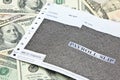 Payroll slip on pile of US dollar banknotes Royalty Free Stock Photo