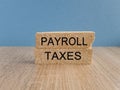 Payroll taxes symbol. Concept words \'Payroll taxes\' on brick blocks