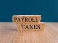 Payroll taxes symbol. Concept words \'Payroll taxes\' on brick blocks