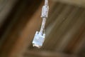 PC computer monitor VGA cable completely covered with dust and cobweb hanging from ceiling at abandoned house Royalty Free Stock Photo