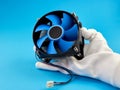 PC CPU cooler with thermal paste. A hand wearing a white glove holds the CPU cooler of the computer Royalty Free Stock Photo