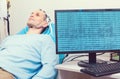 PC displaying brain waves of male patient at lab