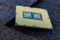Pc micro CPU with gold plated contacts on a textured dark background. Modern central processing unit close-up. Desktop computer