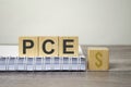 pce text from wooden blocks on a grey wooden background Royalty Free Stock Photo