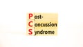 PCS post-concussion syndrome symbol. Concept words PCS post-concussion syndrome on wooden blocks on a beautiful white table white
