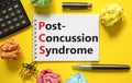 PCS post-concussion syndrome symbol. Concept words PCS post-concussion syndrome on white note on a beautiful yellow background.