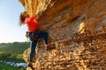 Pcture of curly-haired climber girl climbing rock Royalty Free Stock Photo