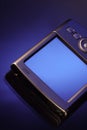 PDA smartphone on isolated blue background. Old style palm PC Royalty Free Stock Photo