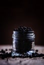 Pea Of Black Pepper In A Glass Jar. Vintage Wood Background, Sel