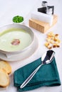 Pea cream soup with bacon in a white plate with toast Royalty Free Stock Photo