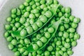 Pea. Green peas pod bowl on gray stone background, top view Royalty Free Stock Photo