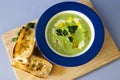 Pea & Ham Soup with Cream & Baguette on Rustic Board Royalty Free Stock Photo