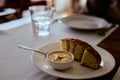 Pea pate with garlic in a small ceramic bowl with pieces of a bun on a white ceramic plate Royalty Free Stock Photo