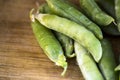 Pea pods close-up on a wooden background