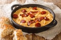 Pea puree with garlic bacon and chorizo close-up in a frying pan. horizontal