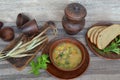 Pea soup with bacon and potato in wooden bowl on rustic table Royalty Free Stock Photo