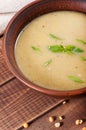 Pea soup in a clay plate on an old wooden background Royalty Free Stock Photo