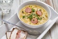 Pea soup with smoked sausage and rye bread with bacon. Royalty Free Stock Photo