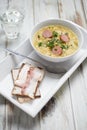 Pea soup with smoked sausage and rye bread with bacon. Royalty Free Stock Photo