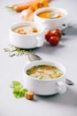 Pea, tomato, vegetable soups and ingredients on concrete background Royalty Free Stock Photo