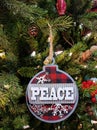 Peace Christmas Ornament on Pine Tree Royalty Free Stock Photo