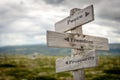 peace freedom prosperity text on wooden signpost