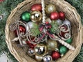 Peace & greetings in basket, colorful, sparkly Christmas balls.