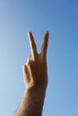 Peace hand on blue sky Royalty Free Stock Photo
