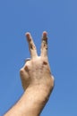 Peace hand on blue sky Royalty Free Stock Photo