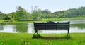 Peace of mind on empty garden bench on quiet lake side corner