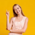 Peace. Playful Teen Girl Showing Two Fingers Gesture And Smiling Royalty Free Stock Photo