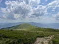 Poland - Bieszczady - View of the low mountains, white clouds and stone path in summer day.