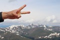 Peace sign over mountains