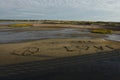 Peace Sign Rock Design on a Sand Beach