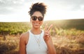 Peace sign, travel and black woman on safari holiday during summer in Kenya. Portrait of a happy, relax and African girl Royalty Free Stock Photo