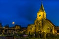 Peace and solitude of a medieval church and cemetery at night in Sanderstead, Croydon, UK