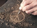 The peace symbol carved in wood with chisels. Peace concept, global solidarity Royalty Free Stock Photo