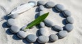 Peace symbol formed with smooth grey stones and a delicate feather on white sand, symbolizing harmony Royalty Free Stock Photo