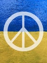 Peace symbol on Ukrainian flag painted on wall Royalty Free Stock Photo