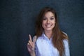 Peace to the world. Portrait of a beautiful young businesswoman giving a peace sign.