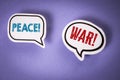 Peace versus War. Two speech bubbles on a violet background Royalty Free Stock Photo