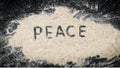 PEACE word written on white sand