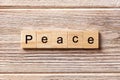 Peace word written on wood block. Peace text on table, concept Royalty Free Stock Photo