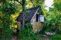 Peaceful abandoned old cottage at summer sunset in the woods