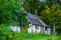 Peaceful abandoned old cottage at summer sunset in the woods