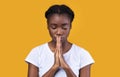 Peaceful African Lady Praying Standing With Eyes Closed In Studio