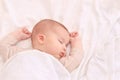 Peaceful baby lying on a bed while sleeping in a bright room Royalty Free Stock Photo