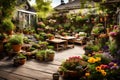 A peaceful backyard garden with a wooden deck and a variety of potted plants and flowers in full bloom